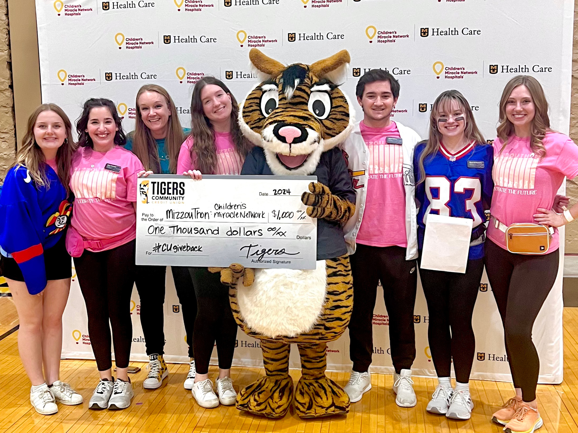 Tigers Community Credit Union's Tigersquirrel™ making a donation to Children's Miracle Network at Mizzouathon.
